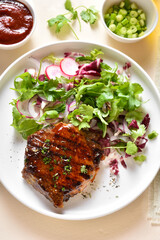 Roasted pork steak with salad from fresh vegetable