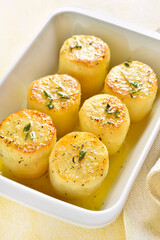 Fondant potatoes in baking dish