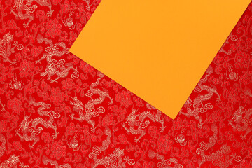 Red fabric with dragon pattern with yellow copy space for text. The concept of the Chinese New Year. to copy space. Red background