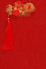 Red fabric with dragon pattern with red copy space for text and golden female hairpin. Concept of Chinese New year and wedding.