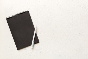 school notebook on a colored background, spiral black notepad on a table Top view