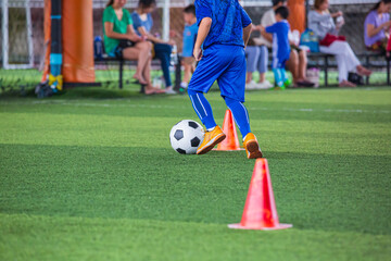 Children playing control soccer ball tactics on grass field with for training