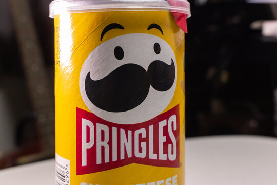 Kumamoto, JAPAN - Sep 3 2021 : Closeup a package of Pringles, an US brand of stackable potato-based crisps (potato chips), on a table.