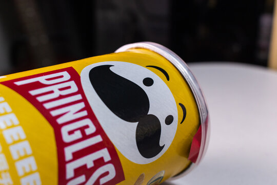 Kumamoto, JAPAN - Sep 3 2021 : Closeup a package of Pringles, an US brand of stackable potato-based crisps (potato chips), on a table.