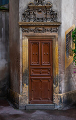 Old italian vintage door. Entrance door of an old building on a narrow street in a medieval town.