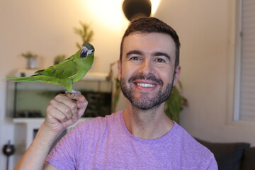 Man with a traditional green parrot 