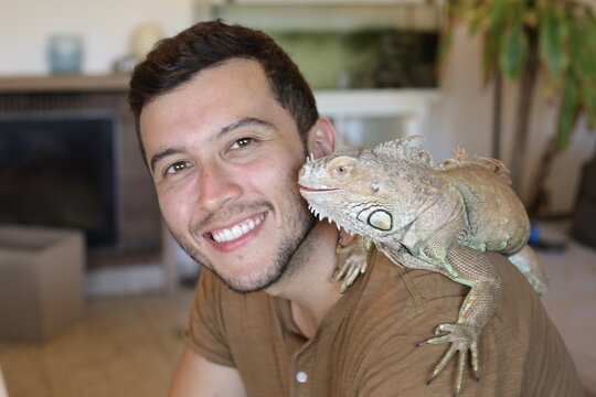 Handsome ethnic man and his spectacular Iguana