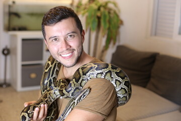 Man with beautiful pet snake  - Powered by Adobe