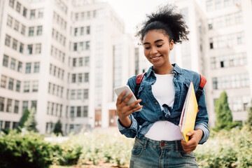 Happy African Student Girl Using Phone With Educational App Outdoors