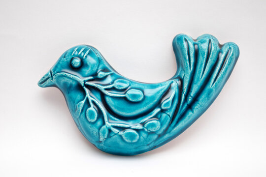A blue ceramic bird. The blue bird is a symbol of happiness.