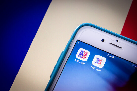 Kumamoto, JAPAN - Oct 20 2021 : TousAntiCovid and TAC Verif on iPhone on French flag in dark mood. TousAntiCovid is contact tracing app for monitoring the spread of the COVID-19 pandemic in France.