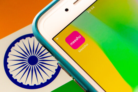 Kumamoto, JAPAN - Oct 25 2021 : Meesho app on iPhone on Indian flag. It is an Indian social e-commerce company specialized in providing an online platform for small businesses to sell products
