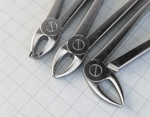 Dentists Pliers On Paper Surface