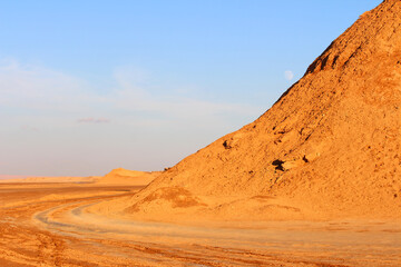 A mountain of sand in the Sahara Desert at sunset.