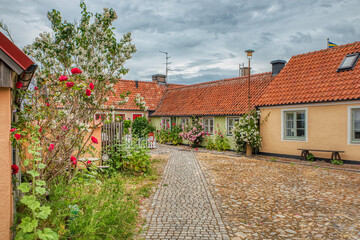 Cobbled town square in a small, touristic fishermen village in the Osterlen region shows a cosy  neighbourhood and traveller location. The cozy town conveys a sense of community. Simrishamn, Sweden