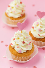 Valentine's day pastry. Cupcakes decorated hearts on a pink background