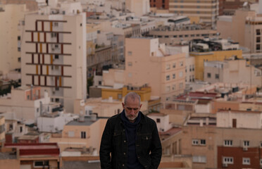 Portrait of adult against city, Almeria, Andalusia, Spain
