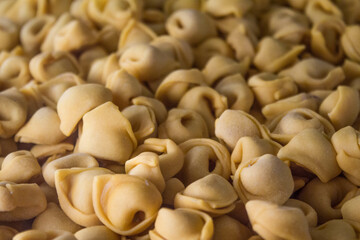 Pile of filled fresh organic tortellini pasta