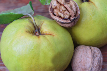 half a walnut with a kernel on two fresh quince