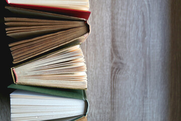 Bunch of vintage hardcover books on wooden background. Top view.