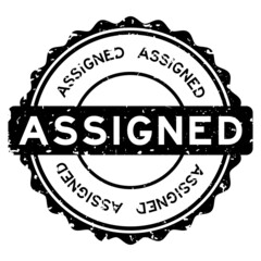 Grunge black assigned word round rubber seal stamp on white background