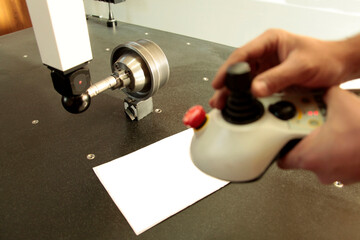 CMM probe measuring on steel cylinder. CMM probe Machine control controller.