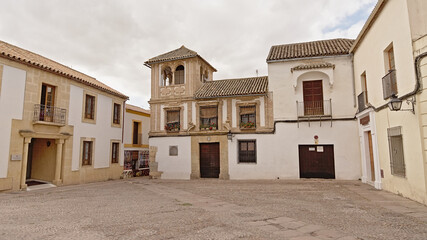 Fototapeta na wymiar Square wiht tradtional houses and little tower in Cordoba, Spain