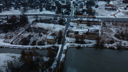 Flying in a suburban park. City blocks are visible. Winter cityscape. Aerial photography.