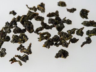 Dry tea leaves isolated on a white background.
