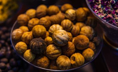 Dried Lemons or lime are displayed in a bazaar or in a street market stall. Dubai Grand Spice Souk old souq, United Arab Emirates.