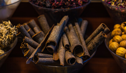 Cinnamon sticks display in a bazaar or in a street market stall. Dubai Grand Spice Souk old souq, United Arab Emirates.