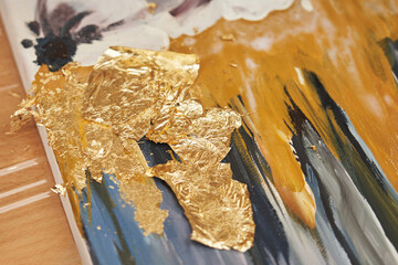 a thin sheet of gold leaf on a piece of painting