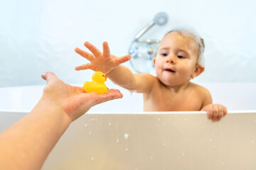 A child bathes in a bubble bath. Selective focus.