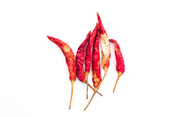 Six dried red hot chilies on a white background.