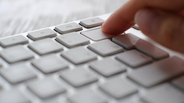 Enter button pressing on keyboard, laptop keyboard close up