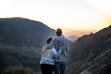 Couple In Love Watching Mountain Sunrise in Yosemite National Park After Hike