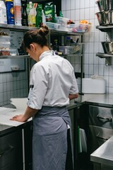 professional chef  in white jacket working in the kitchen