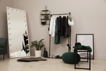 Modern dressing room interior with clothing rack and mirror