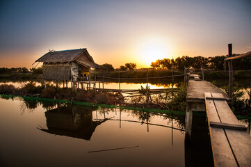 thai local house with wood way, sunset on the river