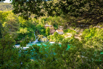 Obraz na płótnie Canvas Waterfalls at Krka river, Croatia. Part of the Skradinski Buk waterfall. Famous place in nature park - beautiful tourist destination in Croatia. Fresh green nature, summer weather.