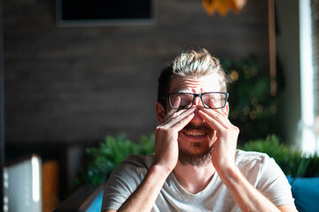 young cheerful bearded man wearing black eye glasses
