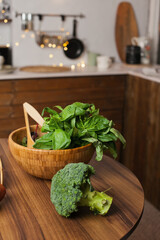 Basil and broccoli on the kitchen table for homemade cooking of healthy vegan meal