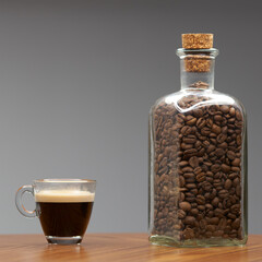 Glass cup of espresso and bottle of coffee beans.   - 480382379