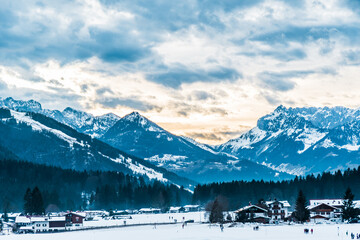 View to the Germand and Austrian Alps from german village Reit im Winkl on an early winter morning, copy space