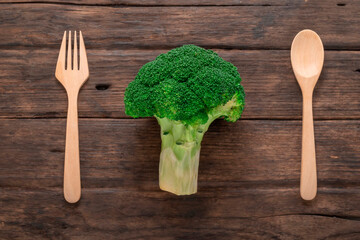Broccoli vegetable on wood has spoon and fork healthy eating clean food concept.