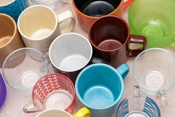 empty mugs of different shapes and sizes on the table