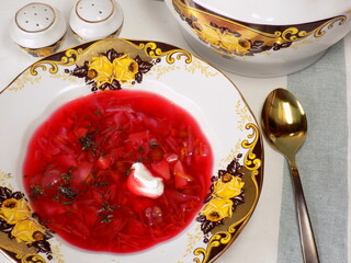 Borscht with herbs and sour cream on the table