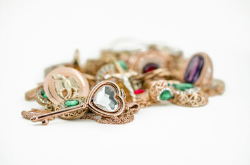 Pile of gold jewelry on white background