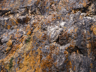 Orange and yellow stone pattern from the wall in the park