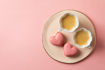 Romantic setup with coffee and heart shaped macarons